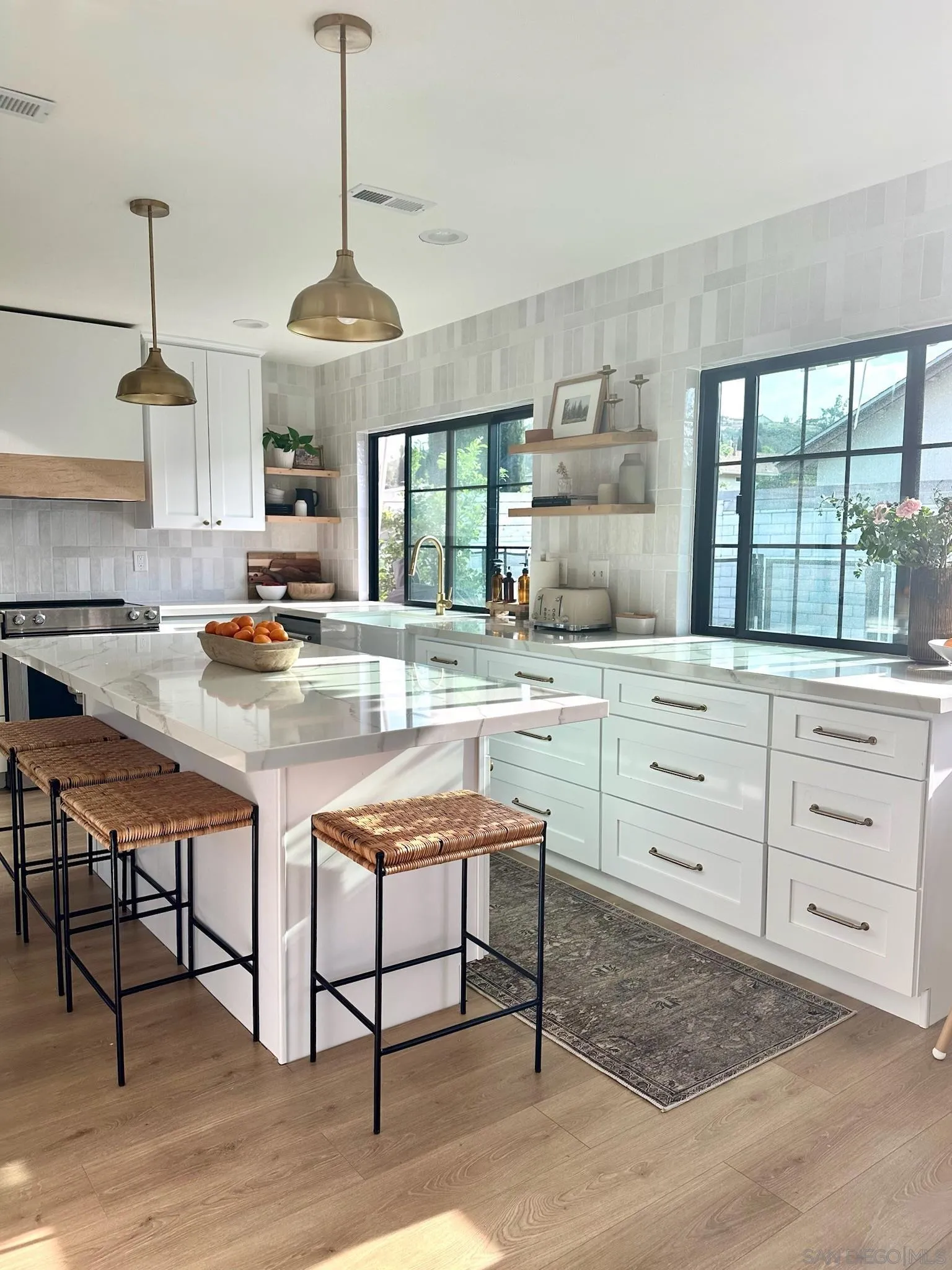 14240 Kendra Way Poway, CA 92064 - Photo 3 of 34 a kitchen with stainless steel appliances kitchen island granite countertop a stove a sink and a wooden floors