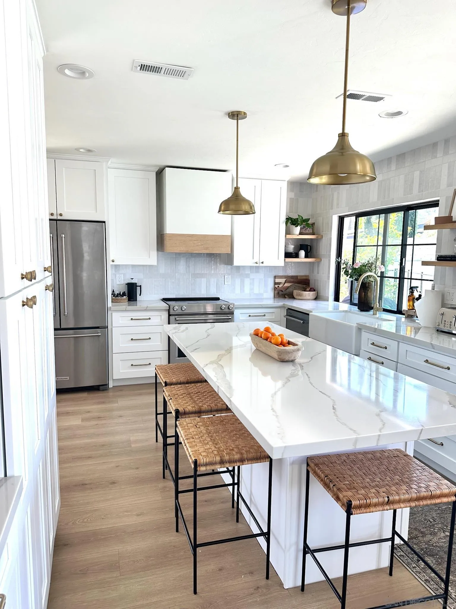 14240 Kendra Way Poway, CA 92064 - Photo 5 of 34 a kitchen with stainless steel appliances kitchen island granite countertop a table chairs and a refrigerator