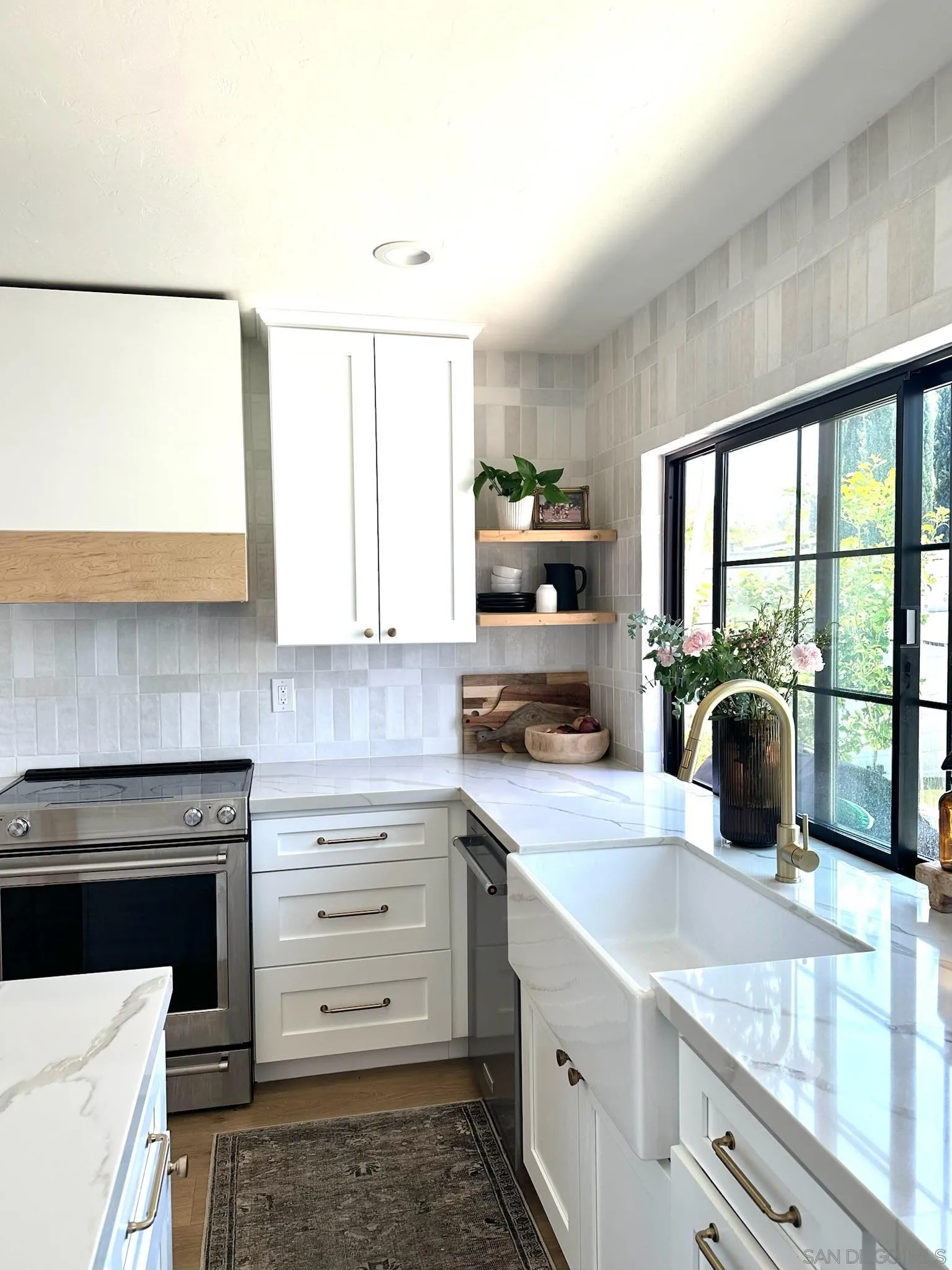 14240 Kendra Way Poway, CA 92064 - Photo 7 of 34 a kitchen with a stove a sink and a granite counter top
