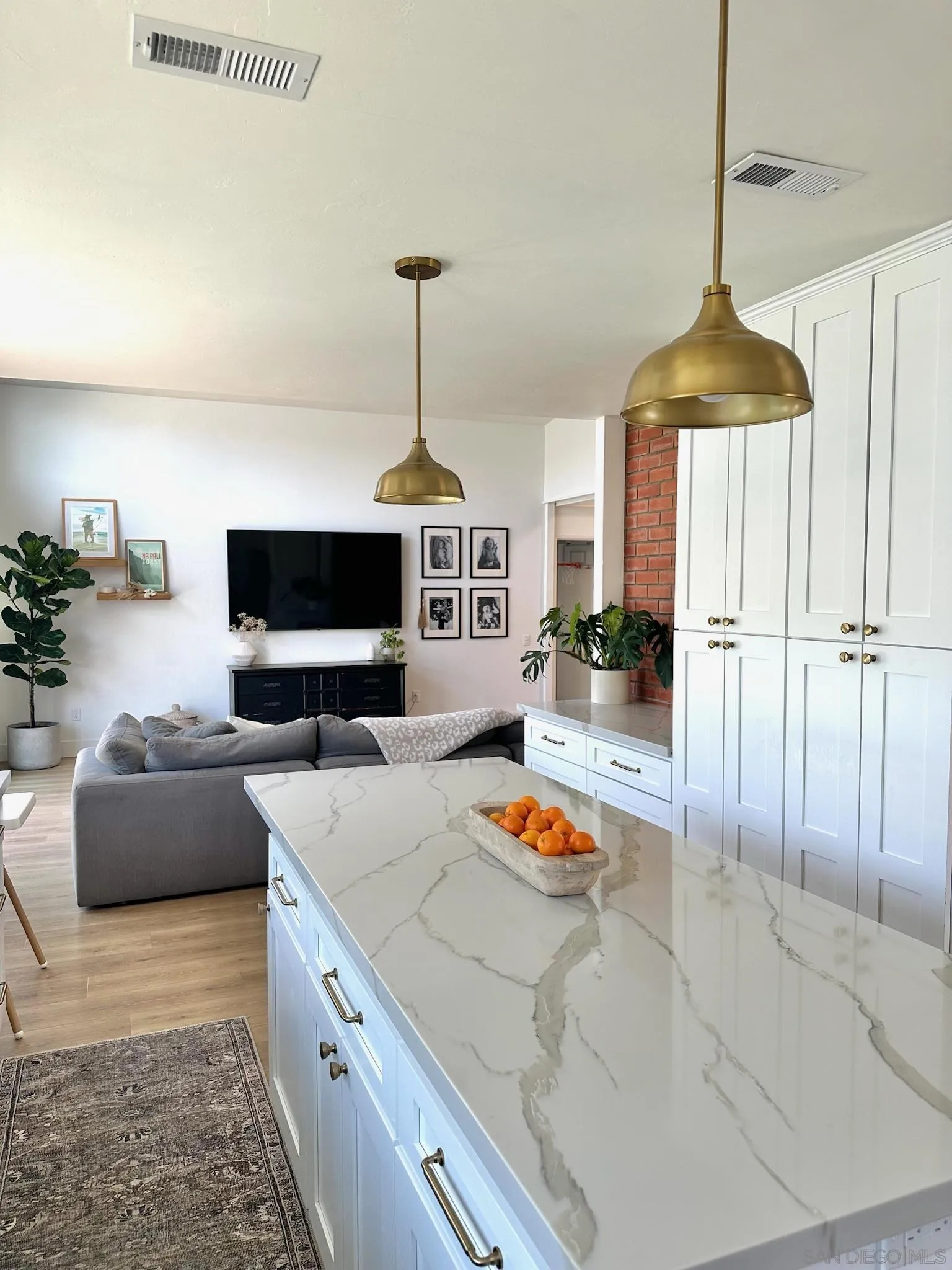 14240 Kendra Way Poway, CA 92064 - Photo 9 of 34 a kitchen with stainless steel appliances granite countertop a stove and a flat screen tv