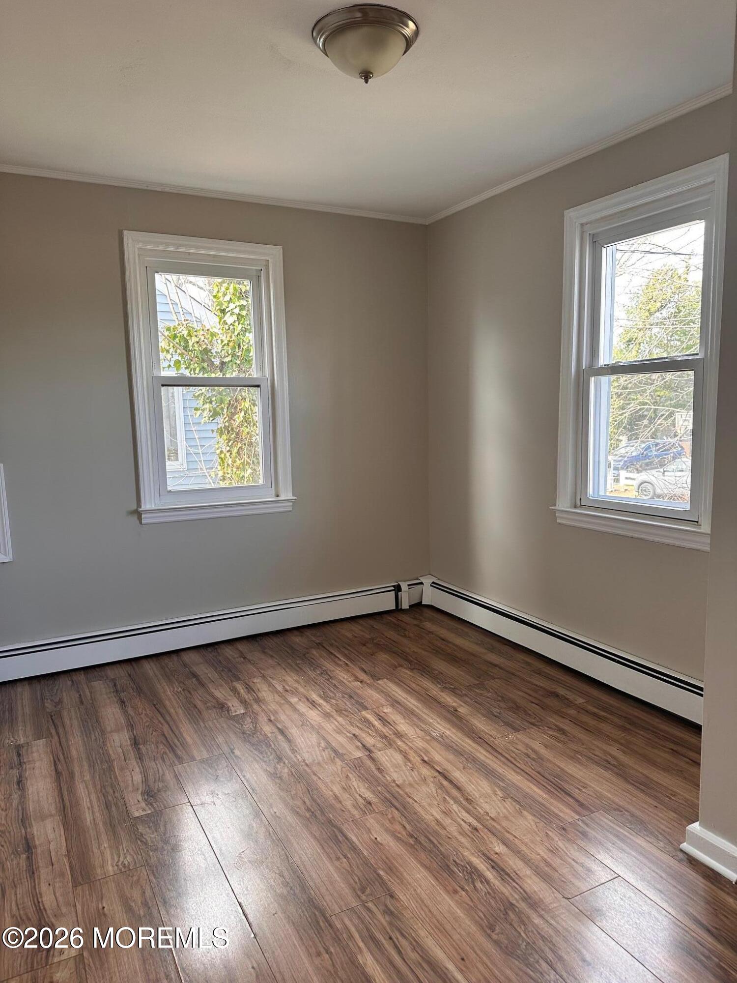 294 19th Avenue Brick, NJ 08724 - Photo 12 of 15 a view of an empty room with wooden floor and a window