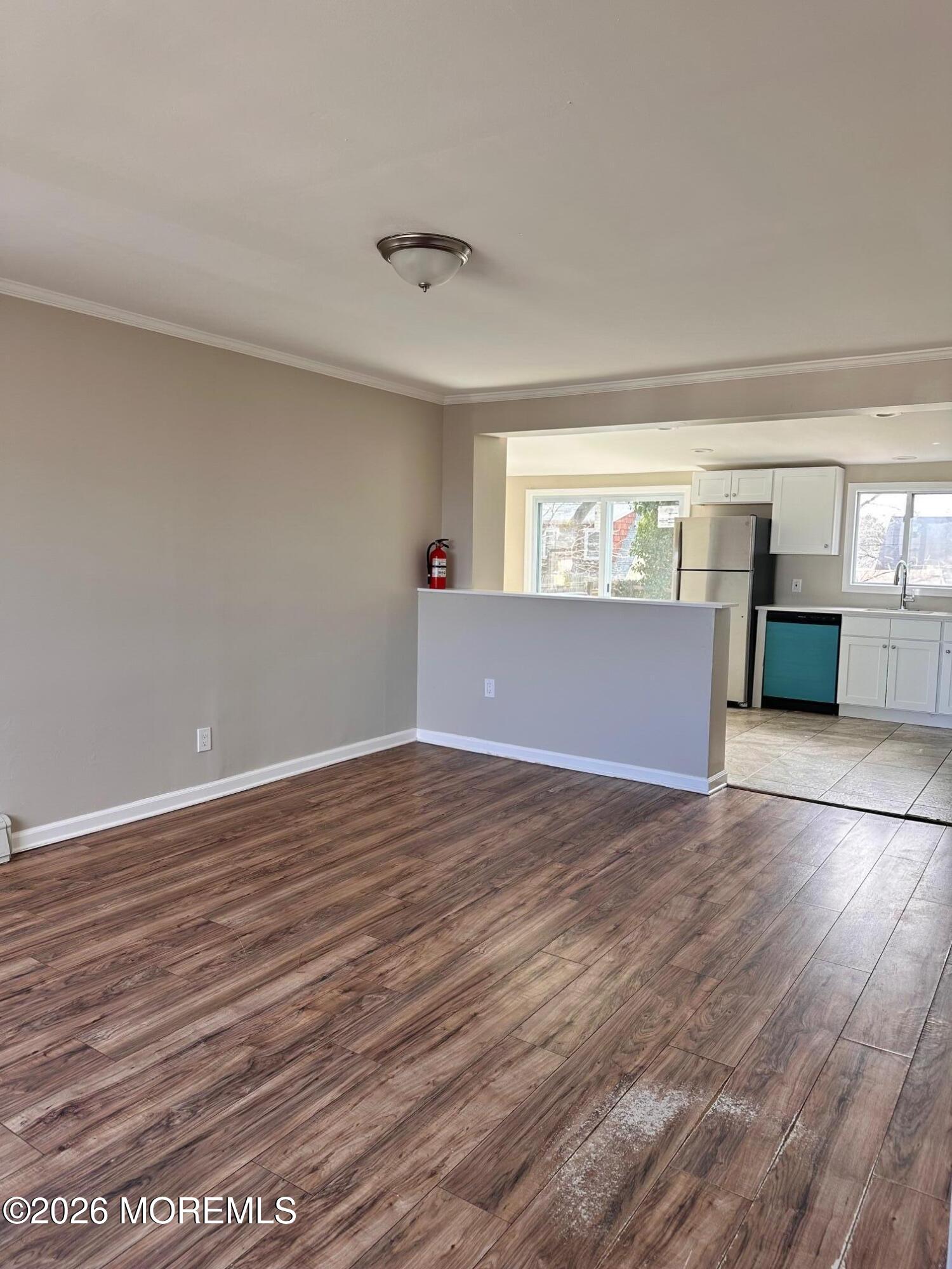 294 19th Avenue Brick, NJ 08724 - Photo 3 of 15 a view of empty room with wooden floor and fan