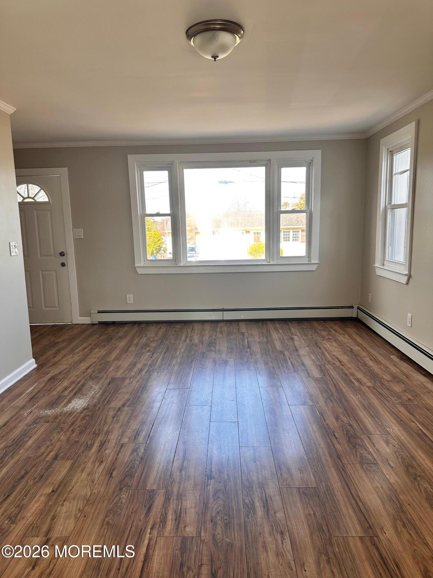 294 19th Avenue Brick, NJ 08724 - Photo 4 of 15 an empty room with wooden floor and windows