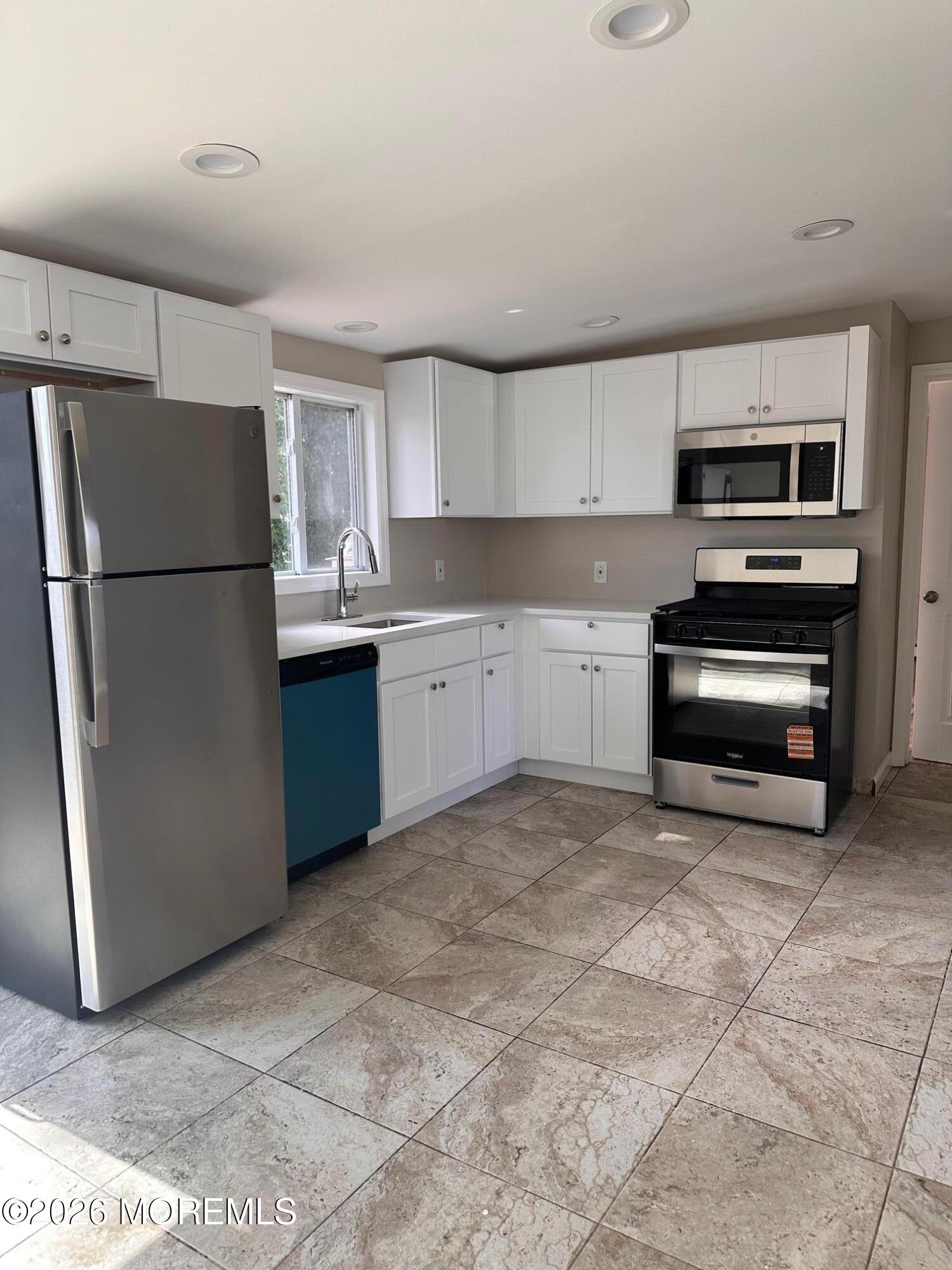 294 19th Avenue Brick, NJ 08724 - Photo 7 of 15 a kitchen with stainless steel appliances a refrigerator sink and microwave
