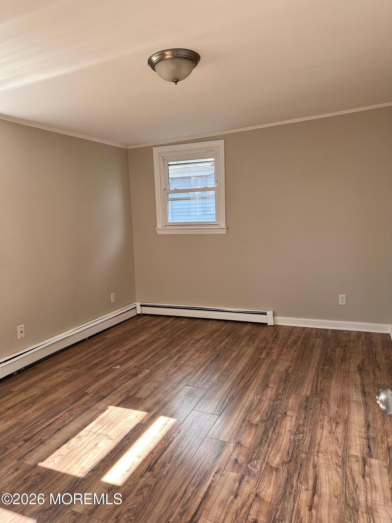 294 19th Avenue Brick, NJ 08724 - Photo 9 of 15 a view of an empty room with wooden floor and a window
