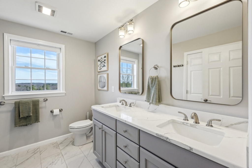 2 Oriole Drive Groton, MA 01450 - Photo 14 of 37 a bathroom with double vanity sinks a toilet and a mirror