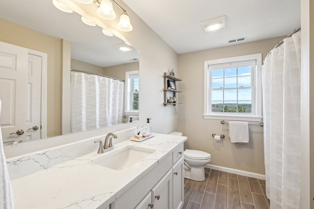 2 Oriole Drive Groton, MA 01450 - Photo 19 of 37 a bathroom with a double vanity sink toilet and a mirror