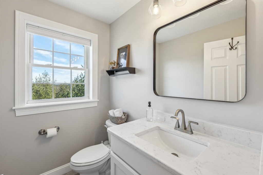 2 Oriole Drive Groton, MA 01450 - Photo 27 of 37 a bathroom with a toilet a sink a mirror and window