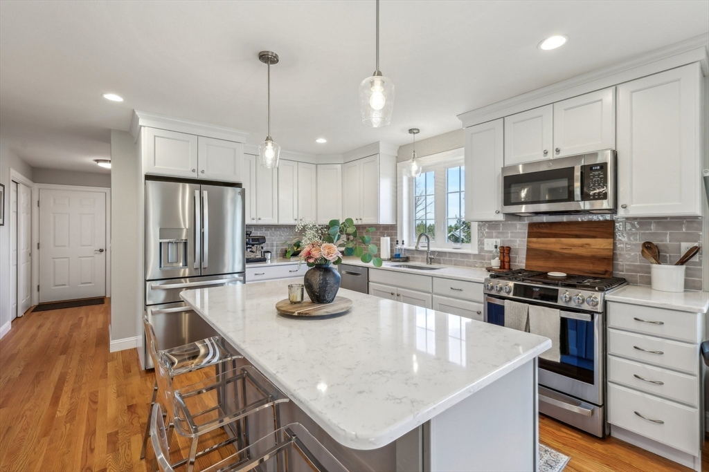 2 Oriole Drive Groton, MA 01450 - Photo 4 of 37 a kitchen with stainless steel appliances granite countertop a sink refrigerator and microwave