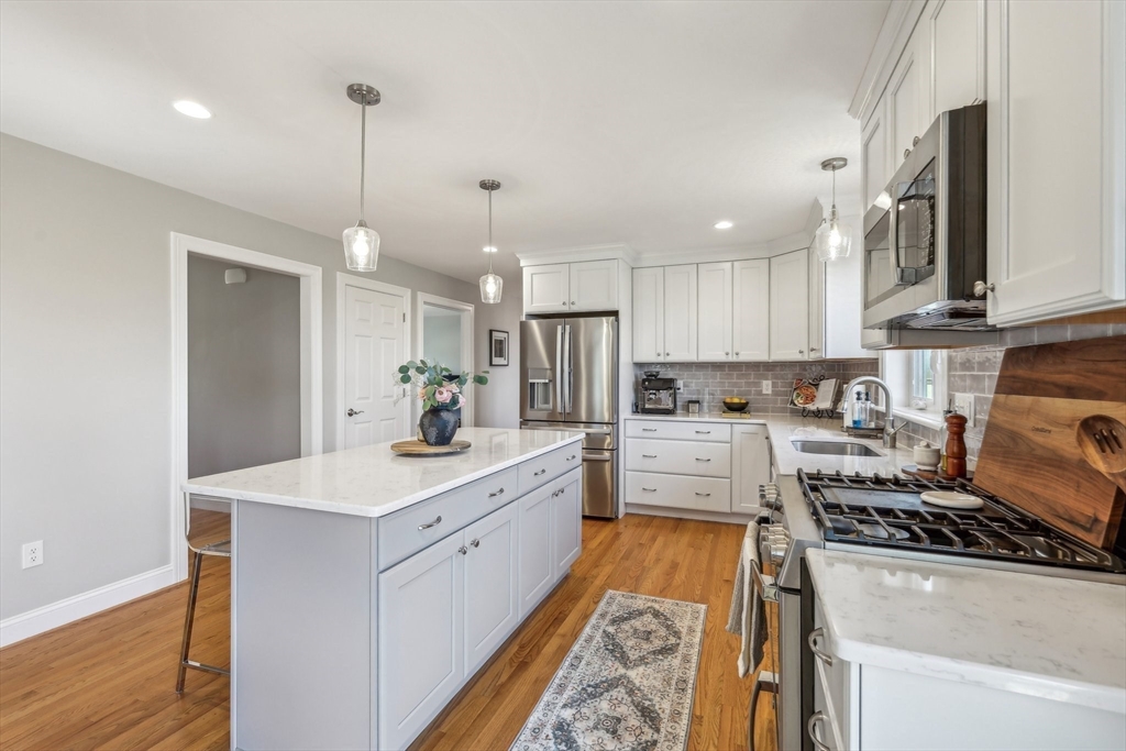 2 Oriole Drive Groton, MA 01450 - Photo 6 of 37 a open kitchen with stainless steel appliances granite countertop a sink stove and refrigerator