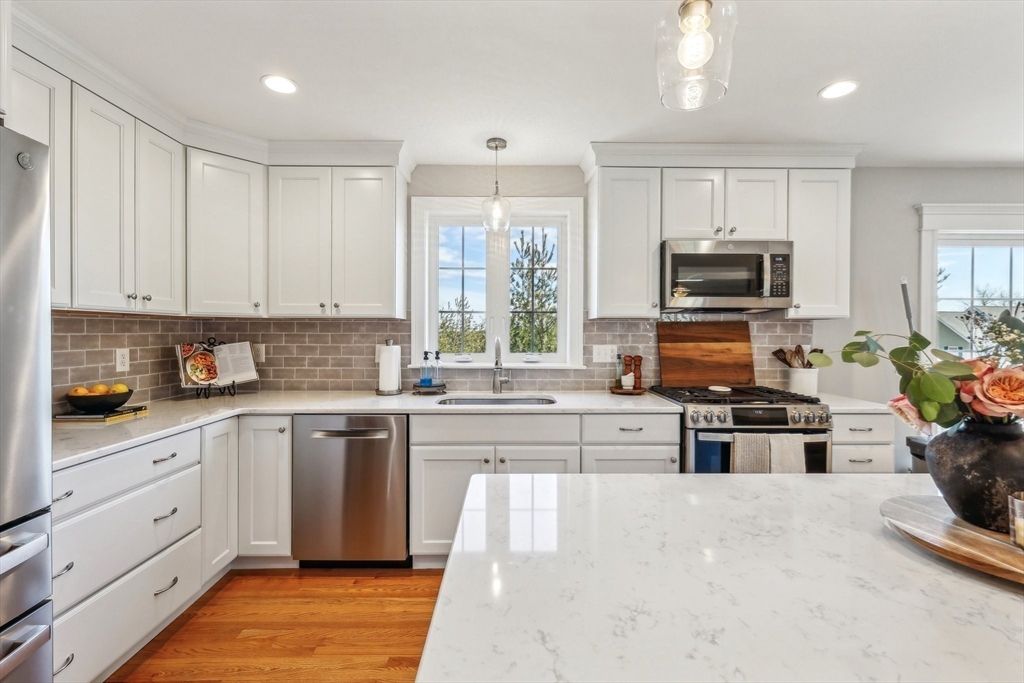 2 Oriole Drive Groton, MA 01450 - Photo 7 of 37 a kitchen with stainless steel appliances granite countertop a stove top oven a sink dishwasher and a refrigerator with wooden floor