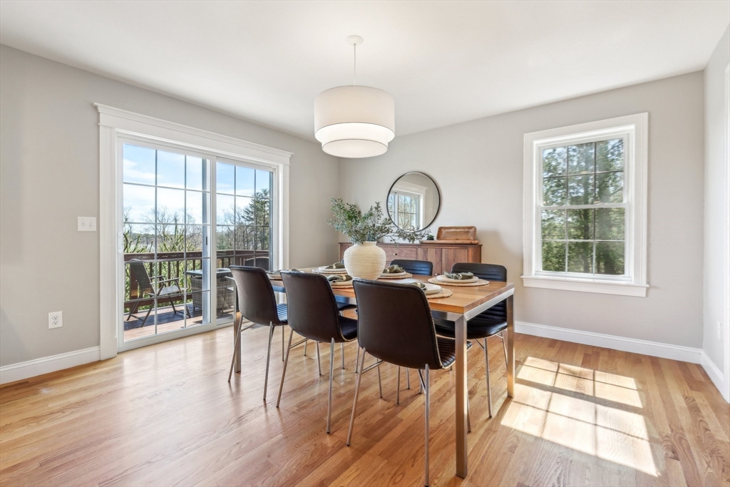 2 Oriole Drive Groton, MA 01450 - Photo 10 of 37 a view of a dining room with a table chairs and wooden floor