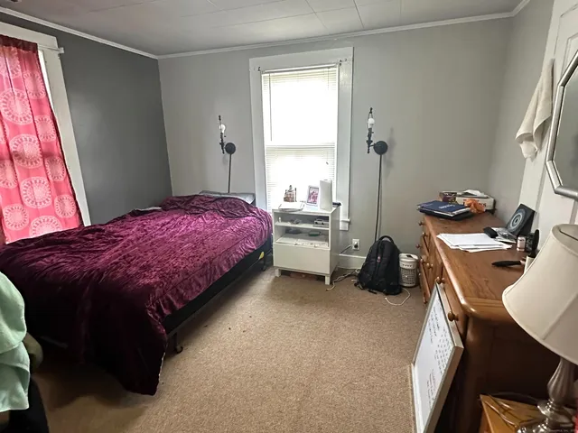 a bedroom with a bed and a desk