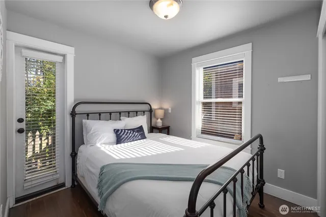 a bedroom with a bed and windows