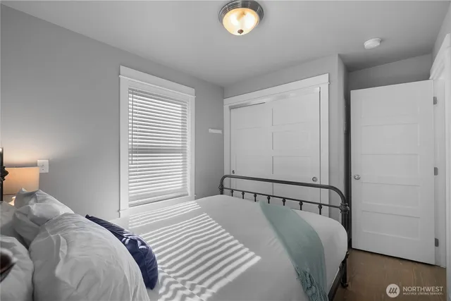 a bedroom with a bed and a window