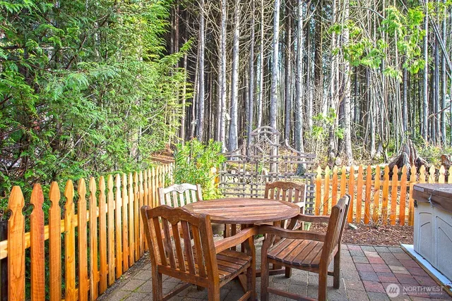 a view of outdoor dining space with a table and chairs