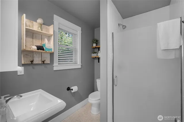 a bathroom with a toilet a sink and a window