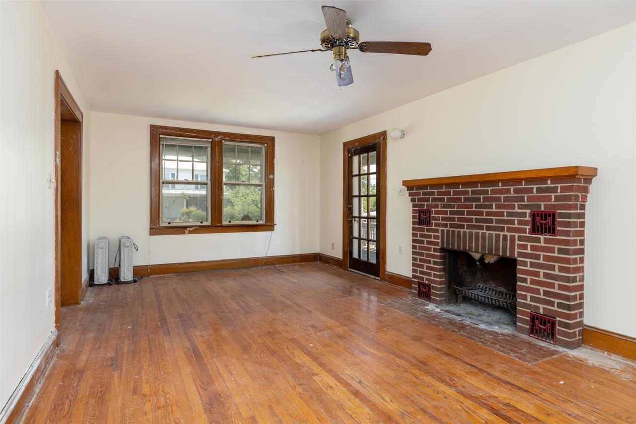 919 Collicello Street Harrisonburg, VA 22802 - Photo 25 of 30 a view of an empty room with wooden floor fireplace and a window