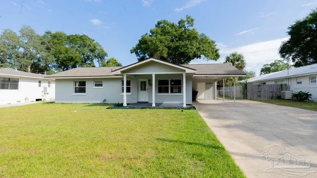 a front view of a house with yard patio and green space