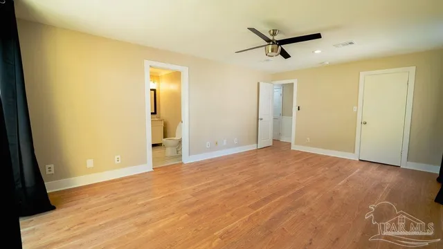 a bathroom with a granite countertop toilet and a sink