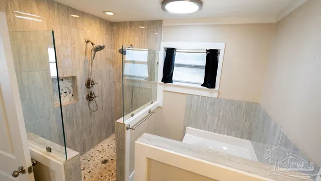 a backyard of a house with large trees and wooden fence