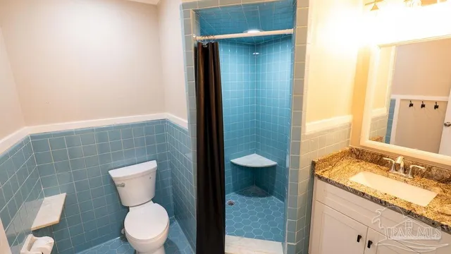 a view of empty room with wooden floor and wall painting