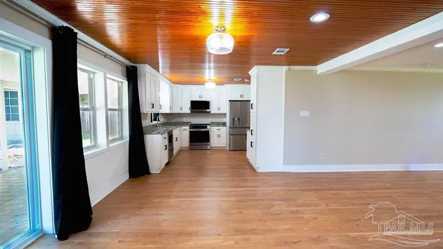 a kitchen with stainless steel appliances a refrigerator and a stove