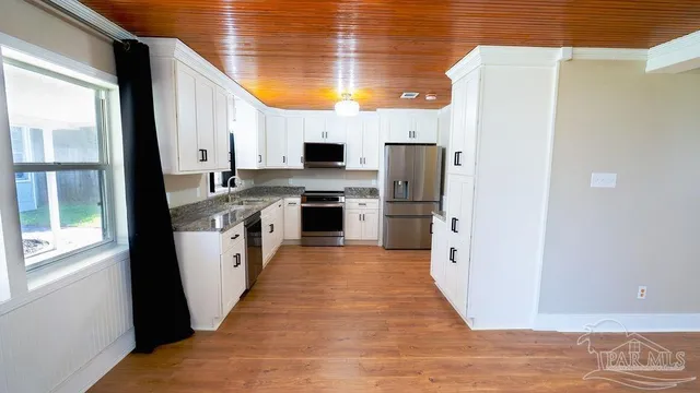 a bathroom with a granite countertop toilet and a sink