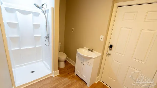 a view of a white house with a yard and large tree