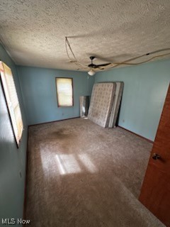 3054 Long Road Akron, OH 44312 - Photo 13 of 18 Carpeted bedroom with a textured ceiling and ceiling fan