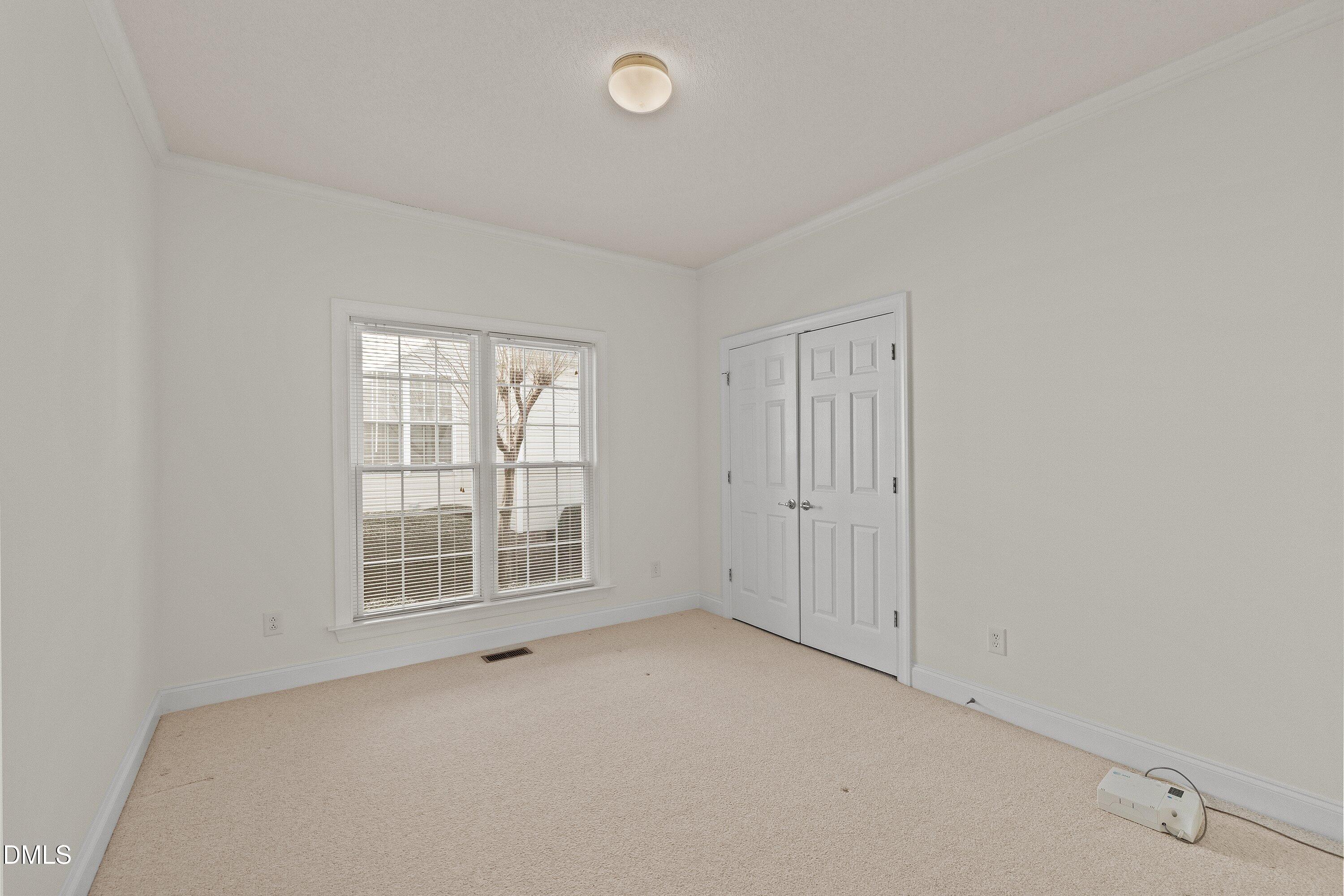 105 Rockport Ridge Way Cary, NC 27519 - Photo 25 of 43 an empty room with windows