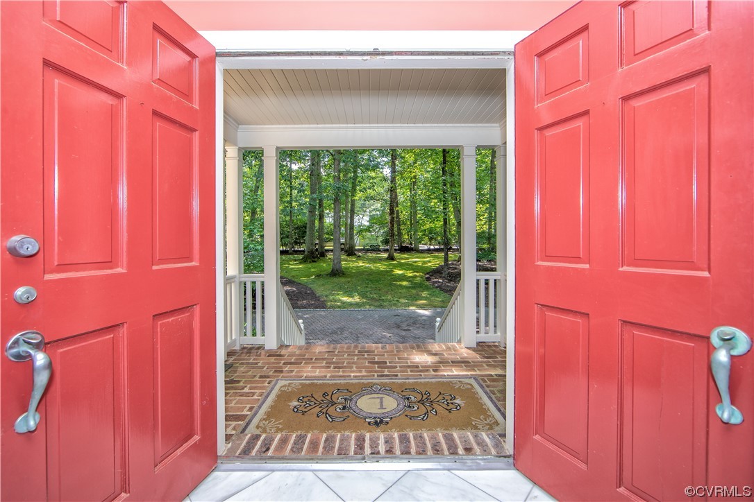 2911 West Brigstock Road Midlothian, VA 23113 - Photo 4 of 50 a view of a door with a red door and a window