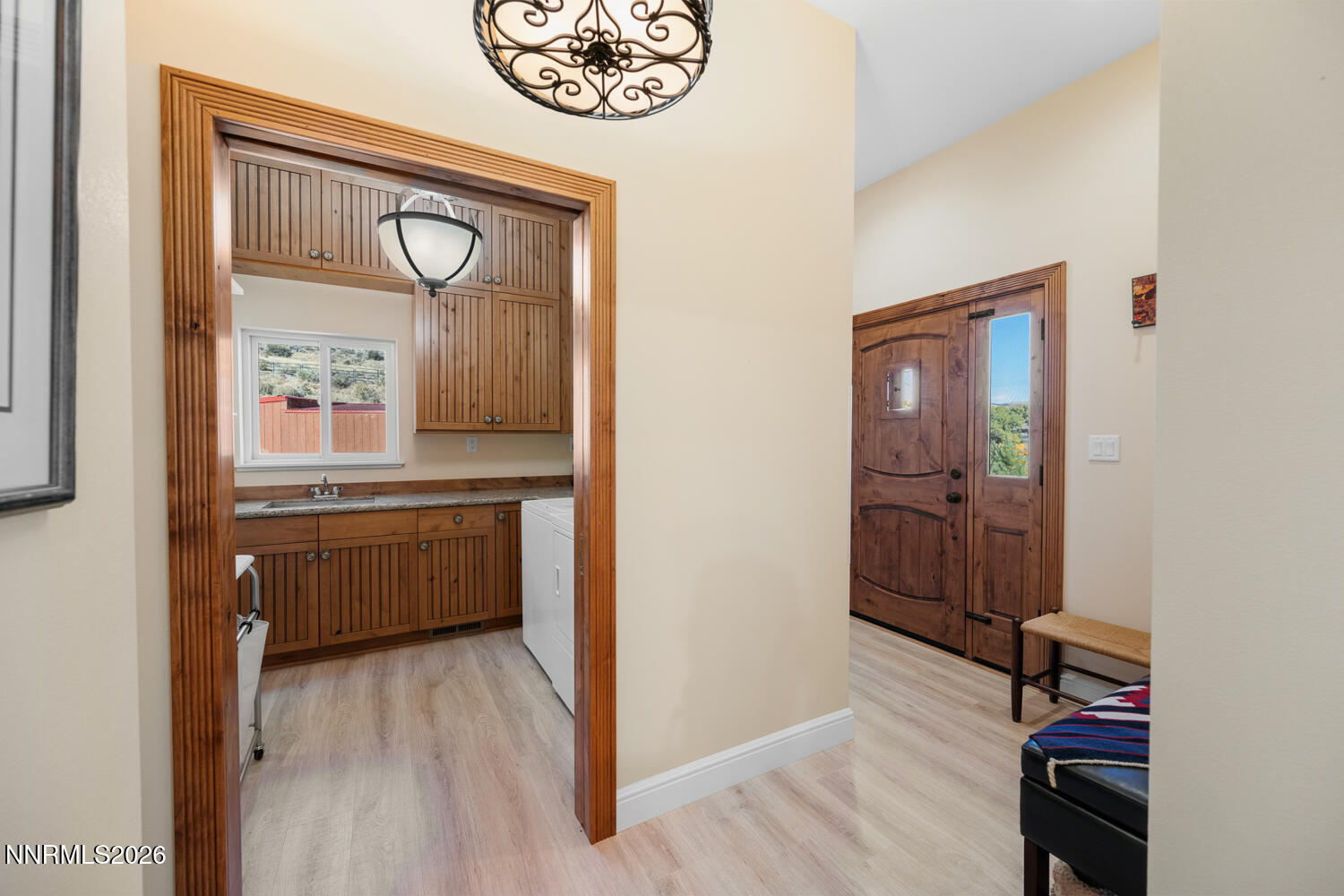 14005 North Red Rock Road Reno, NV 89508 - Photo 28 of 51 a view of a hallway to a room with wooden floor cabinet and windows
