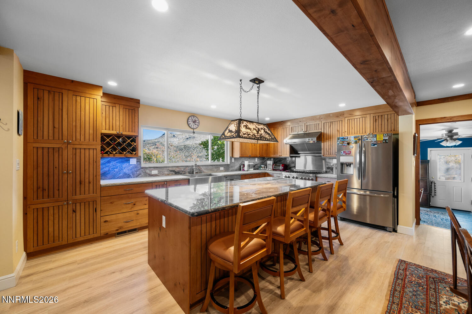14005 North Red Rock Road Reno, NV 89508 - Photo 34 of 51 a kitchen with stainless steel appliances granite countertop table chairs and wooden floor