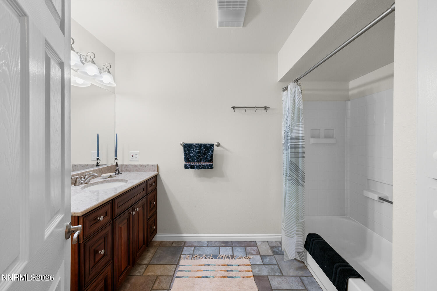 14005 North Red Rock Road Reno, NV 89508 - Photo 42 of 51 a bathroom with a sink a toilet a mirror and shower