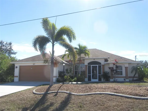 a view of a house with a yard and a street