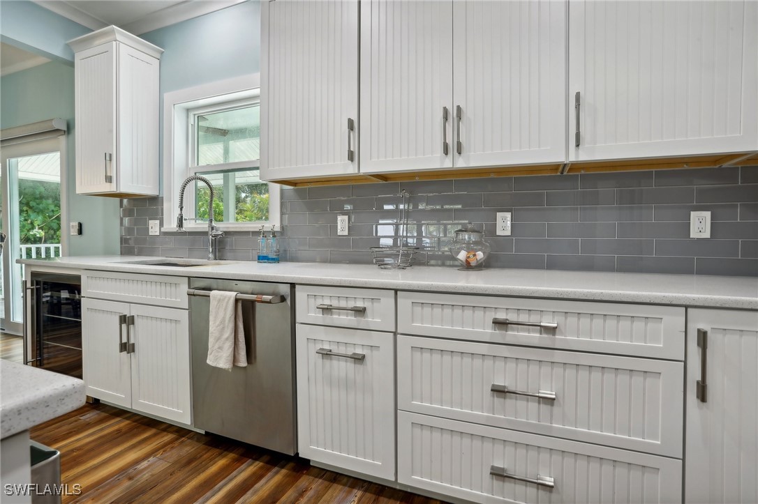 8335 Main Street Bokeelia, FL 33922 - Photo 25 of 47 a kitchen with granite countertop white cabinets and white appliances