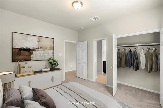 a spacious bedroom with a bed and a walk in closet