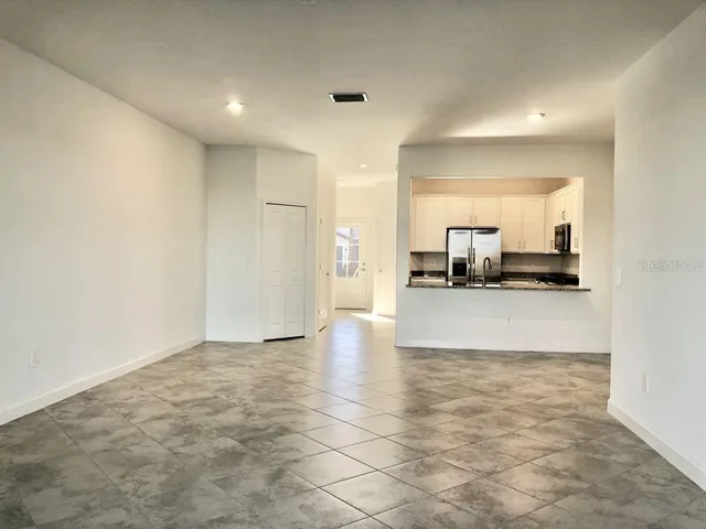 a view of kitchen cabinets and refrigerator