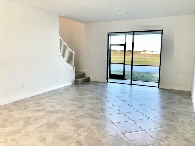 an empty room with large window