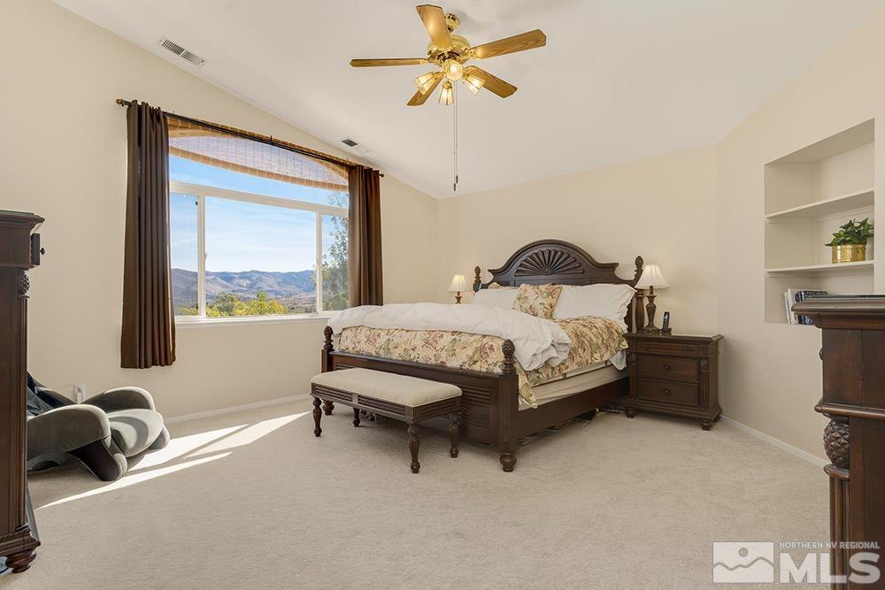 14320 Ghost Rider Drive Reno, NV 89511 - Photo 18 of 40 a bedroom with a bed dresser and a window
