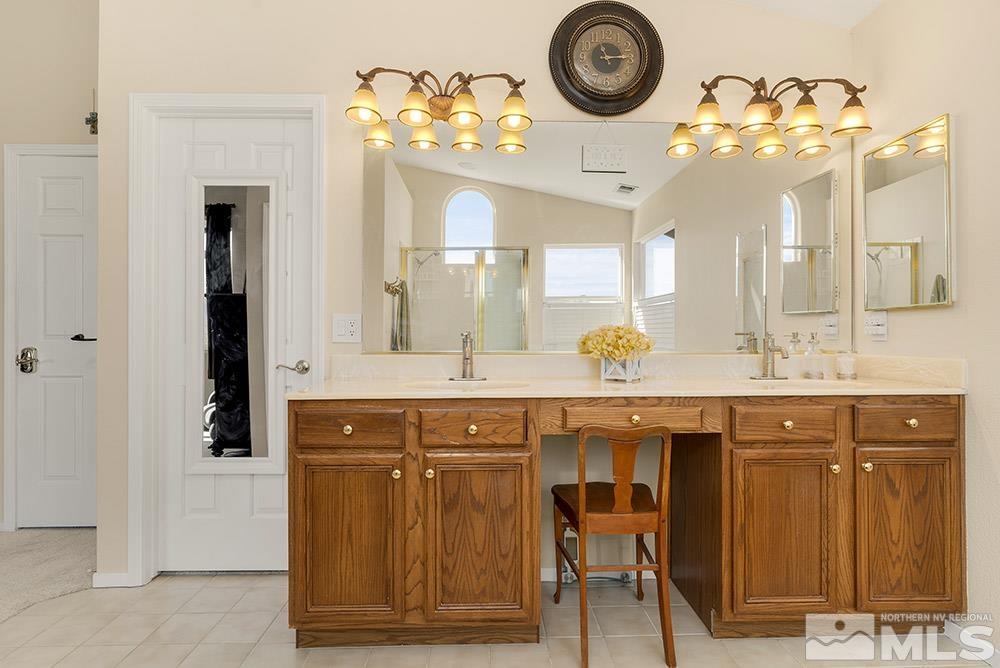 14320 Ghost Rider Drive Reno, NV 89511 - Photo 20 of 40 a bathroom with a sink and a mirror