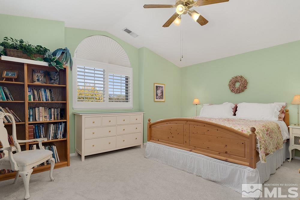 14320 Ghost Rider Drive Reno, NV 89511 - Photo 21 of 40 a bed room with a bed and a book shelf
