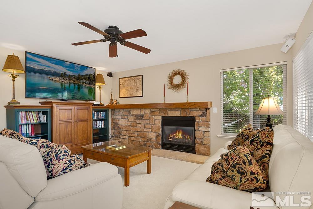 14320 Ghost Rider Drive Reno, NV 89511 - Photo 8 of 40 a living room with furniture fireplace and a large window