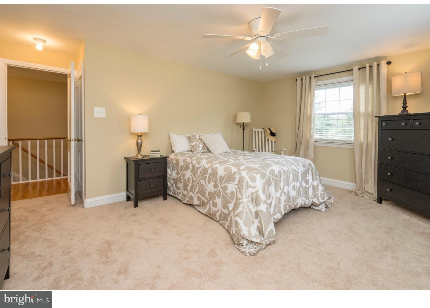 100 Kent Road Springfield, PA 19064 - Photo 15 of 22 a bedroom with a bed and a chandelier