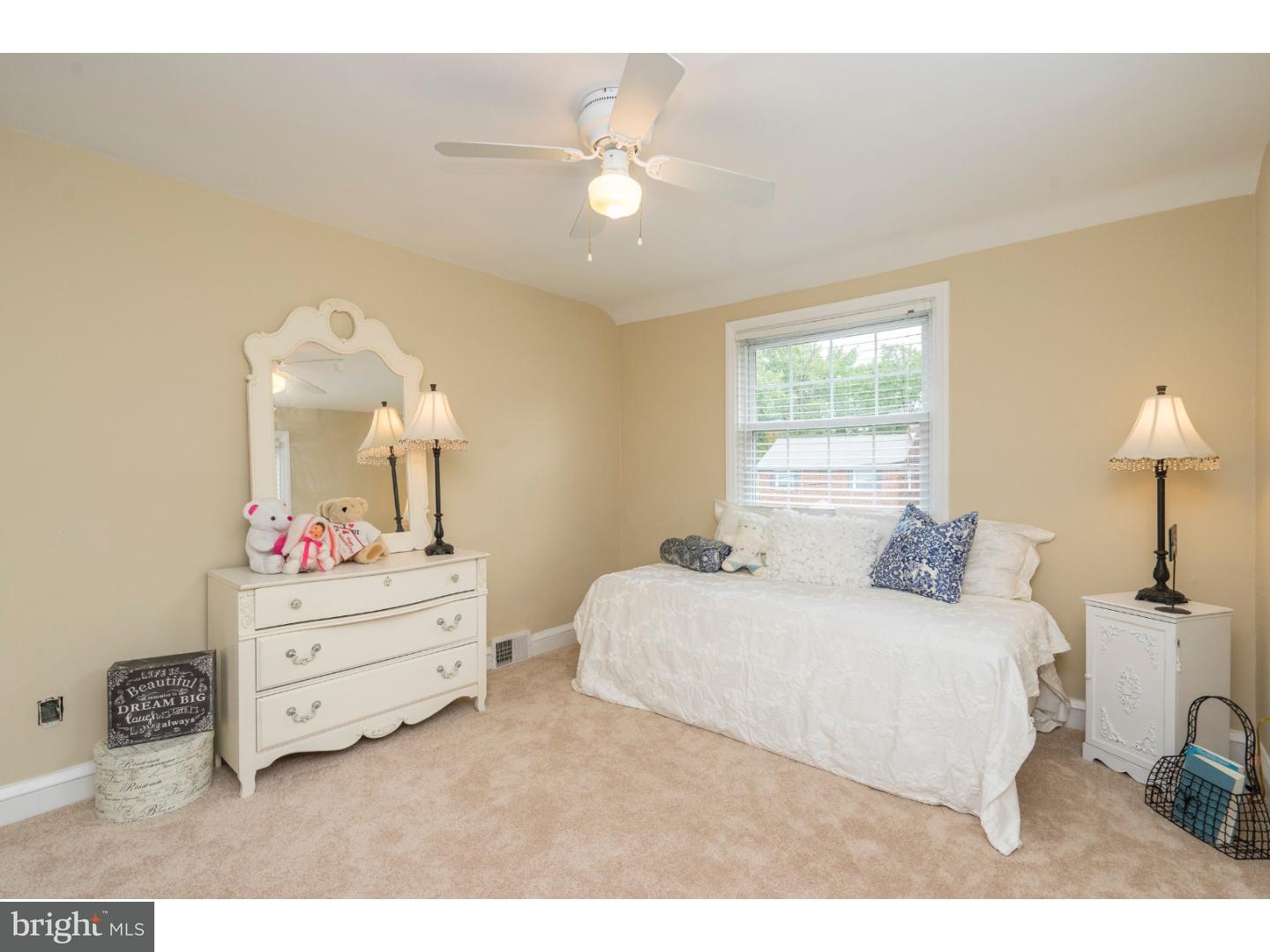 100 Kent Road Springfield, PA 19064 - Photo 16 of 22 a bedroom with a bed and a lamp