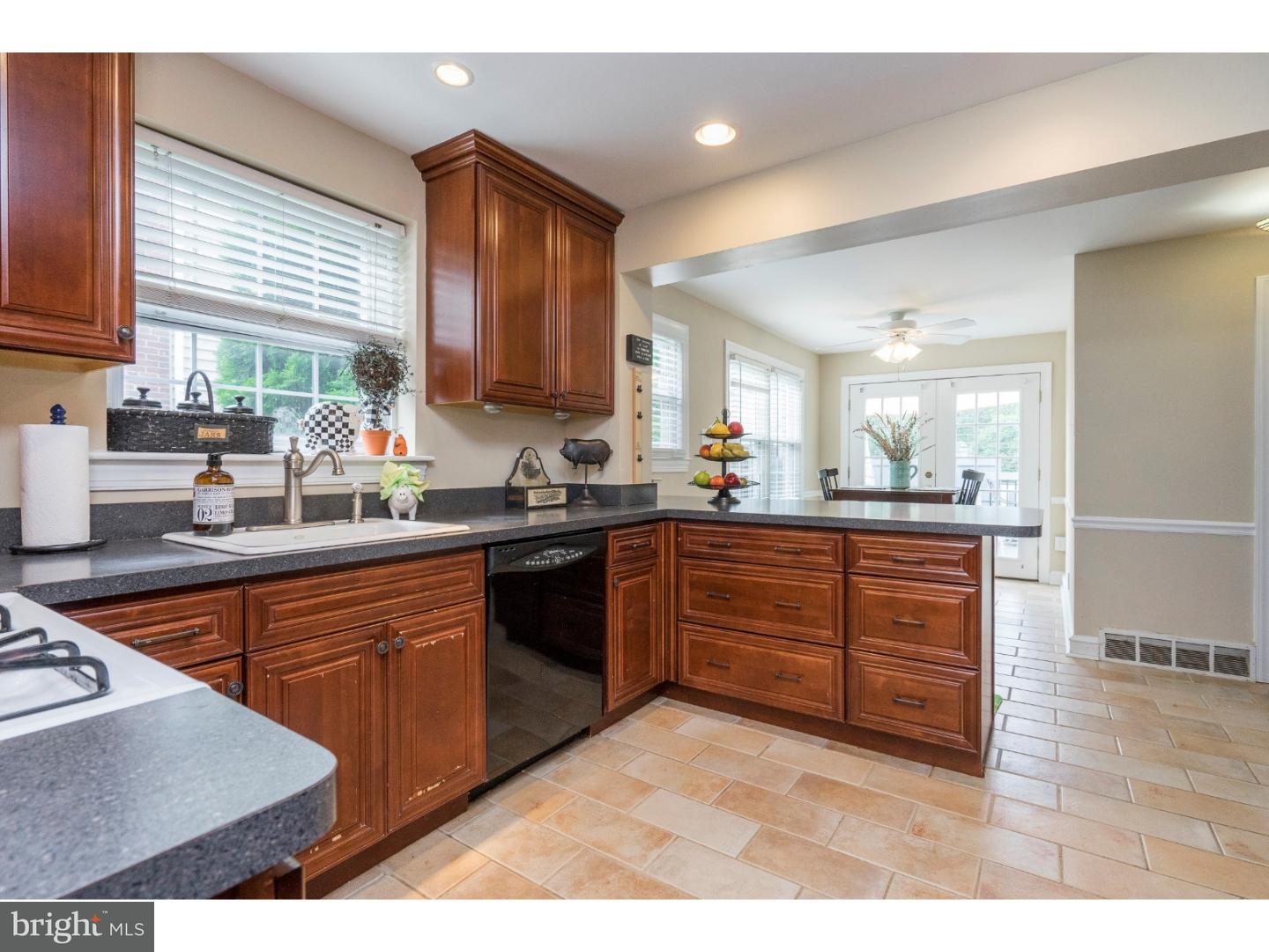 100 Kent Road Springfield, PA 19064 - Photo 6 of 22 a kitchen with stainless steel appliances granite countertop a sink stove and cabinets