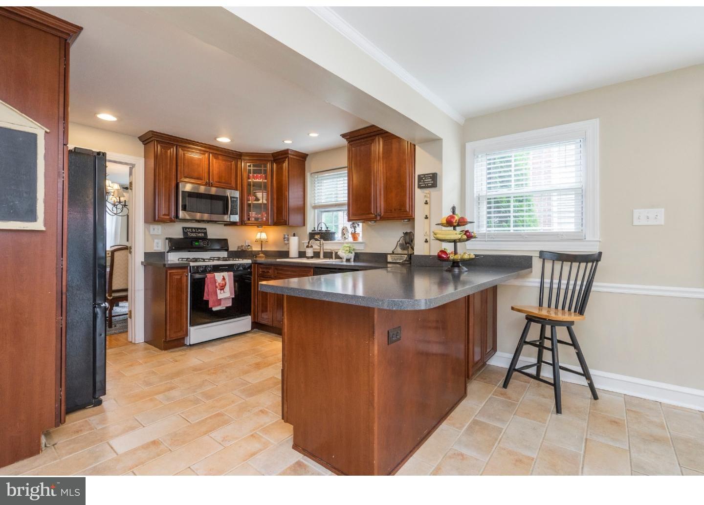 100 Kent Road Springfield, PA 19064 - Photo 7 of 22 a kitchen with stainless steel appliances granite countertop a stove a sink a refrigerator and a dining table