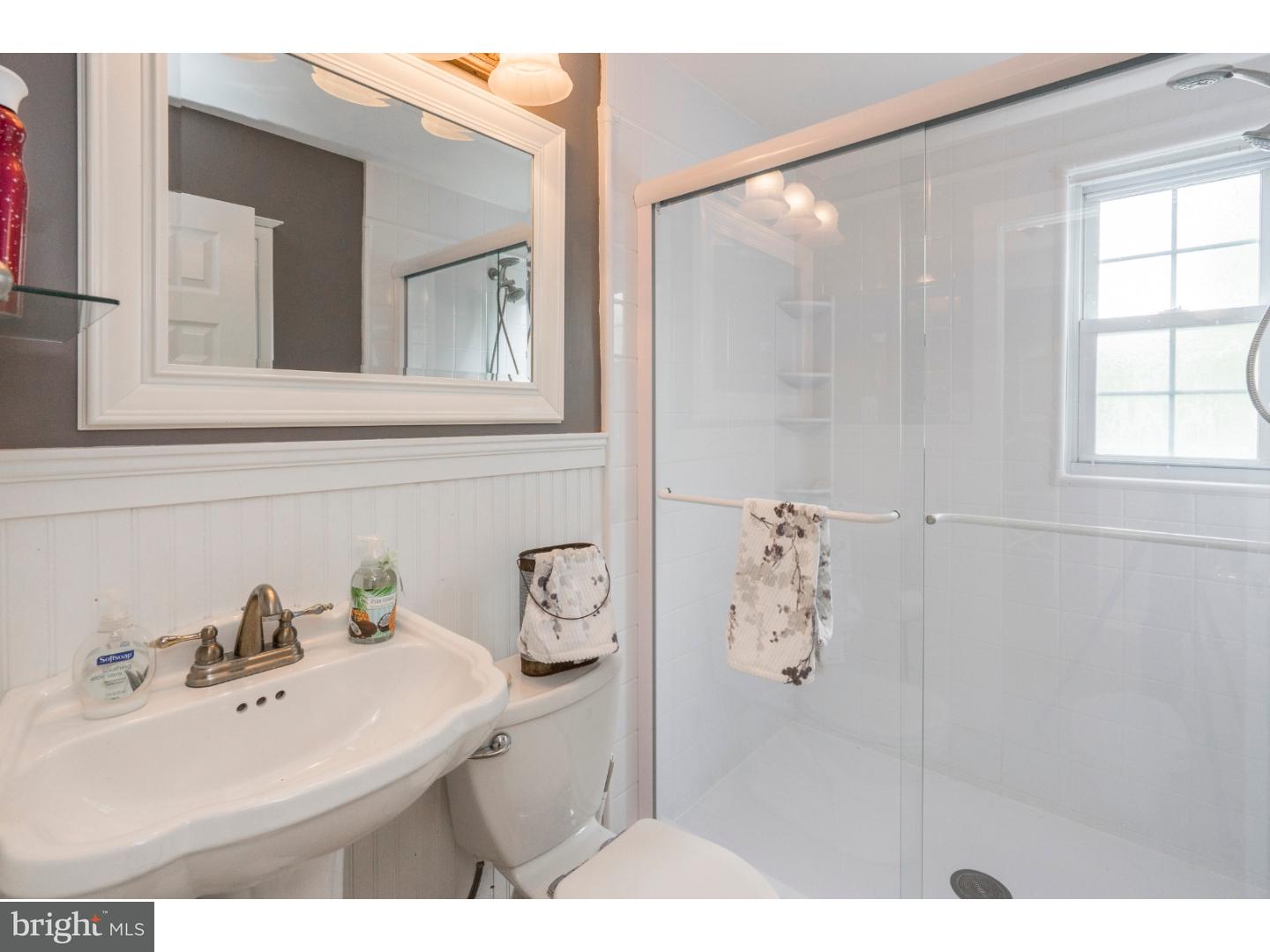 100 Kent Road Springfield, PA 19064 - Photo 10 of 22 a bathroom with a sink and mirror