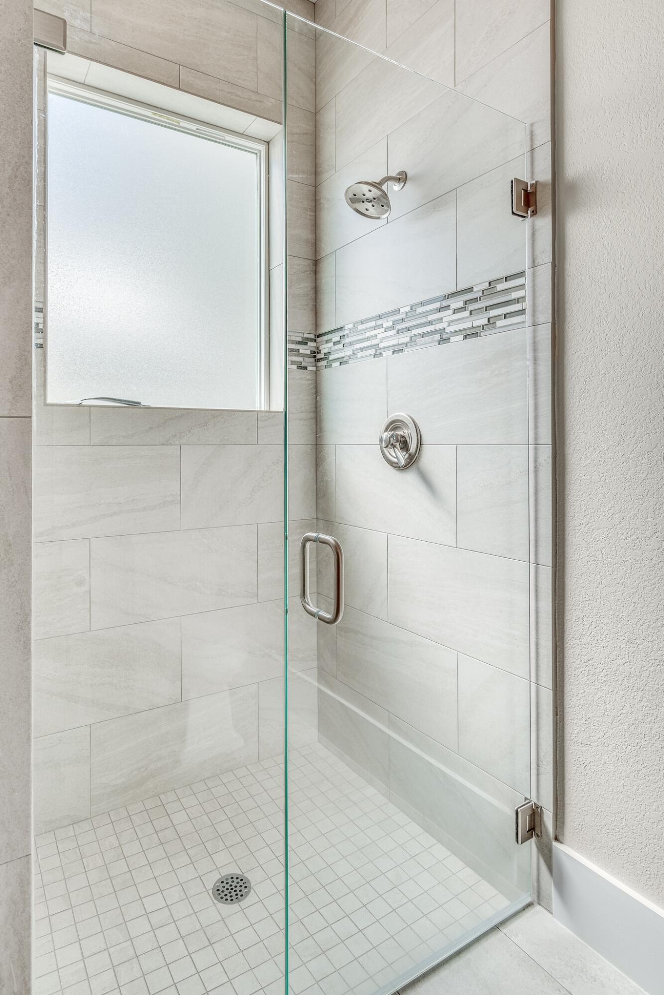 74 Walton Drive Miramar Beach, FL 32550 - Photo 27 of 55 a bathroom with a glass shower door